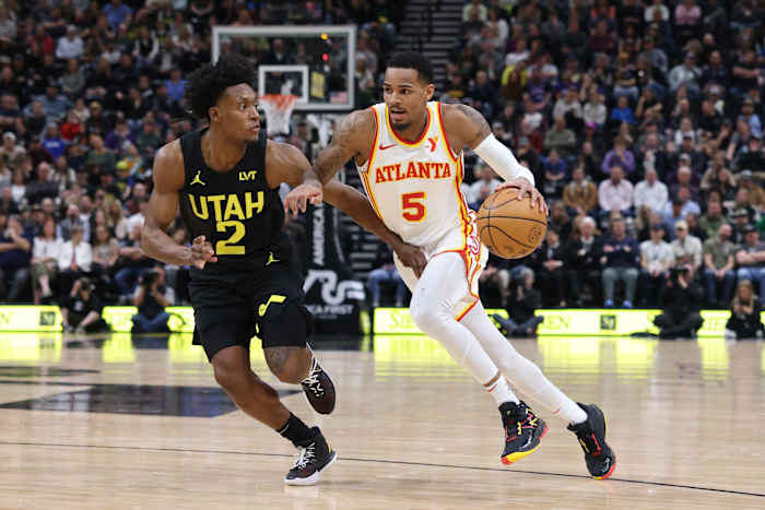 Mar 15, 2024; Salt Lake City, Utah, USA; Atlanta Hawks guard Dejounte Murray (5) drives against Utah Jazz guard Collin Sexton (2) during the second quarter at Delta Center. Mandatory Credit: Rob Gray-USA TODAY Sports